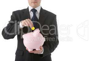 Businessman Putting Coin Into Piggy Bank