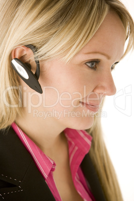 Businesswoman Talking On Hands Free Phone