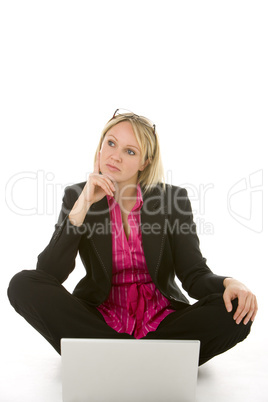 Businesswoman Sitting In Front Of Laptop Thinking