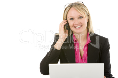 Businesswoman Sitting In Front Of Laptop Talking On Mobile Phone