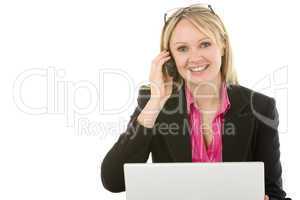 Businesswoman Sitting In Front Of Laptop Talking On Mobile Phone