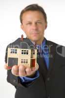Businessman Holding Small House