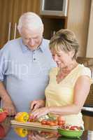 Husband And Wife Preparing Vegetables