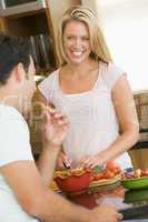 Husband And Wife Preparing Dinner