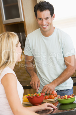 Husband And Wife Preparing Dinner