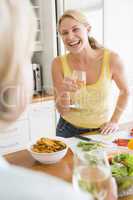 Woman Talking To Friend While Preparing meal,mealtime