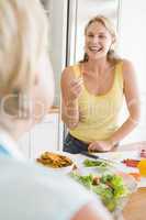 Woman Talking To Friend While Preparing meal,mealtime