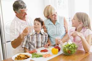 Grandparents And Grandchildren Prepare A meal,mealtime Together