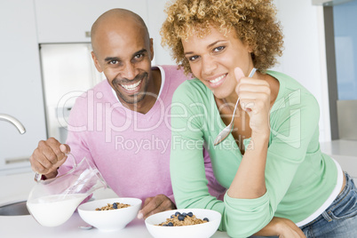Husband And Wife Eating Breakfast Together