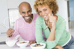 Husband And Wife Eating Breakfast Together