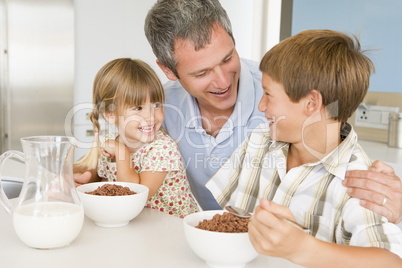 Father Sitting With Children As They Eat Breakfast
