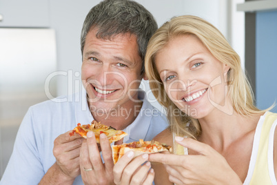 Husband And Wife Eating Pizza
