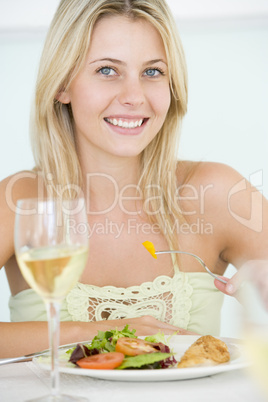 Young Woman Enjoying meal,mealtime With A Glass Of Wine