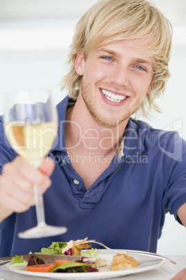 Young Man Enjoying meal,mealtime With A Glass Of Wine