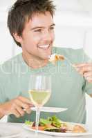 Young Man Enjoying meal,mealtime With A Glass Of Wine