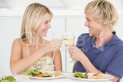 Young Couple Enjoying meal,mealtime With A Glass Of Wine