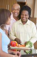 Couple With Daughter Preparing meal,mealtime