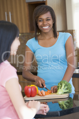 Women Laughing With Friend While Preparing meal,mealtime