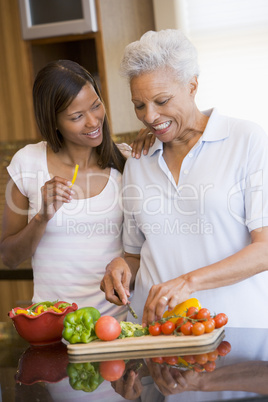 Mother And Daughter Preparing A meal,mealtime Together