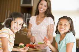 Girls Eating Pepper Strips While Mother Is Preparing meal,mealti