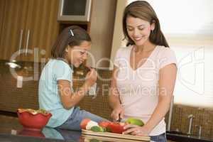 Mother And Daughter Preparing meal,mealtime Together