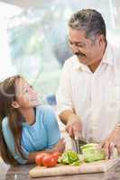 Grandfather And Granddaughter Preparing meal,mealtime Together