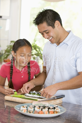 Father And Daughter Preparing Sushi Together