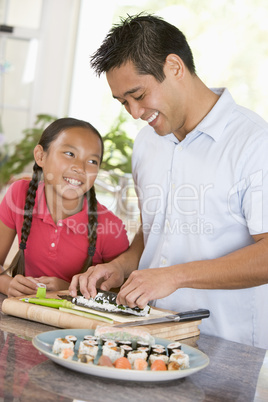 Father And Daughter Preparing Sushi Together