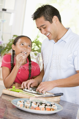 Father And Daughter Preparing Sushi Together