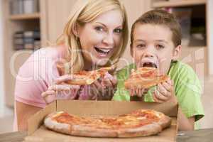 Mother And Son Eating Pizza Together