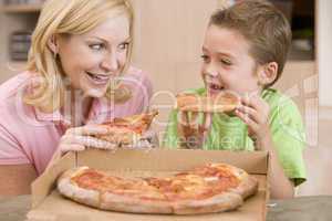 Mother And Son Eating Pizza Together