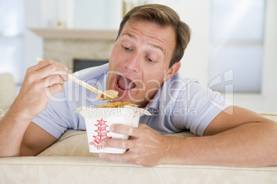 Man Eating Takeaways With Chopsticks