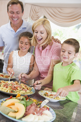 Mother Serving Up Dinner For Family