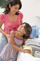 Mother And Daughter Doing Laundry