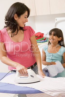 Mother And Daughter Ironing