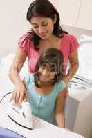 Mother And Daughter Ironing