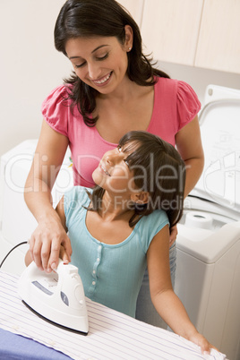 Mother And Daughter Ironing