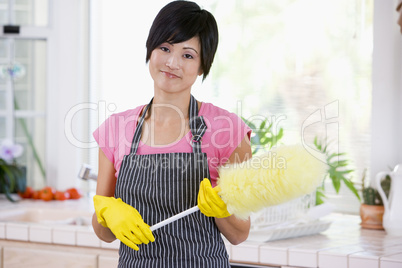 Woman Holding Duster And Wearing Rubber Gloves