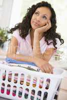 Woman Daydreaming Over Washing Basket
