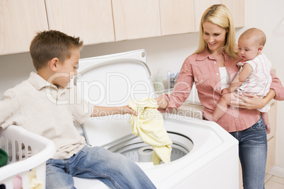 Mother And Children Doing Laundry