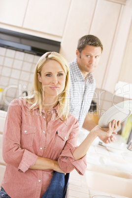 Husband And Wife Doing Dishes