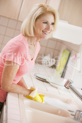 Woman Cleaning Kitchen Counter