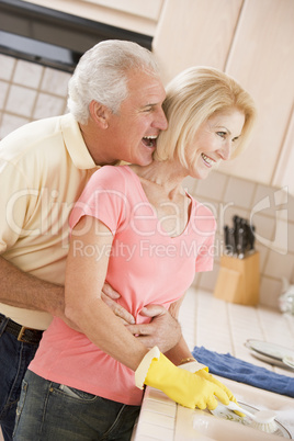 Husband And Wife Cleaning Dishes