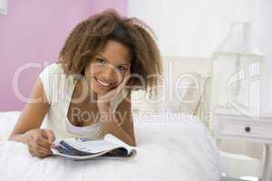 Teenage Girl Lying On Bed Reading