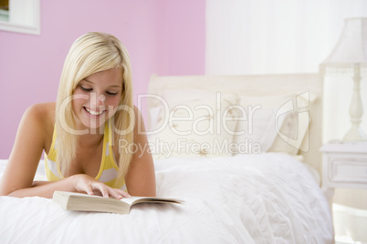 Teenage Girl Lying On Bed Reading