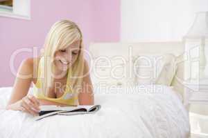 Teenage Girl Lying On Bed Reading