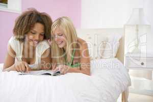 Teenage Girls Lying On Bed