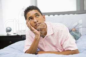 Teenage Boy Lying On Bed