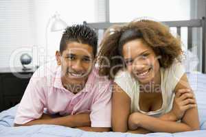 Teenagers Lying On Bed Together