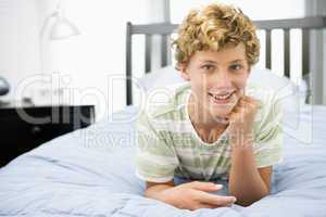 Teenage Boy Lying On Bed